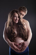 Portrait of young pregnant woman and man