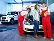 Customer and mechanic in a garage looking at a quotation