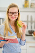 Photo: Happy teenager girl eating sandwich and reading book Happy teenager girl eating sandwich and reading book