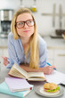 Photo: Thoughtful teenager girl studying in kitchen Thoughtful teenager girl studying in kitchen