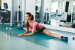 Attractive young fitness model exercising in the gym