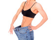 woman with strong abs shows her old big jeans