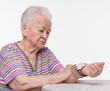 Old woman measures arterial pressure