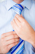 Photo: Business man fixing his tie Business man fixing his tie