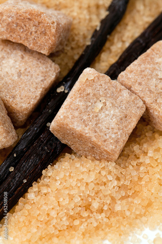 Photo: vanilla beans and brown vanilla sugar isolated on white backgrou vanilla beans and brown vanilla sugar isolated on white backgrou