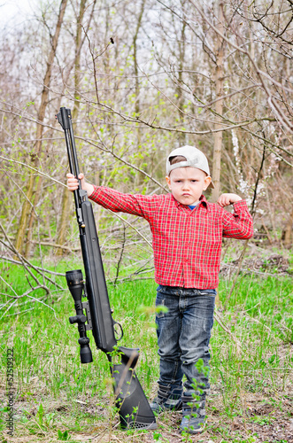 Photo: Cute little boy holding a big rifle Cute little boy holding a big rifle