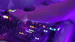 Female Dj hands playing set in night club party