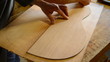 Luthier draws shape guitar in wood