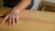 Luthier cuts wood with guitar shape
