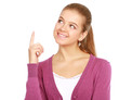 Portrait of a smiling young woman pointing up