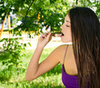 Woman eating a delicious chocolate ice cream in the park