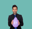 Foto: Young businessman with purple balloon Young businessman with purple balloon