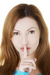 Woman with finger on her lips.