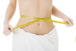 Attractive woman measuring her waist
