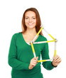 Woman holding a ruler in the form of a house