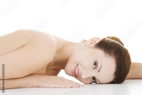 Photo: Sexy fit naked woman lying down Sexy fit naked woman lying down