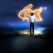 Photo: Businessman drawing gold fish Businessman drawing gold fish