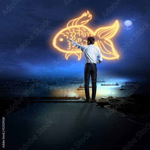 Photo: Businessman drawing gold fish Businessman drawing gold fish