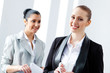 Photo: Two attractive business women smiling Two attractive business women smiling