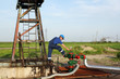 oil worker check pipeline on oilfield