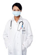 Female surgeon posing with hands in lab coat
