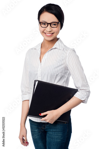 Photo: Smiling female executive holding business files Smiling female executive holding business files