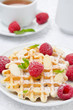 waffles with fresh raspberries and nuts for breakfast, close-up