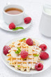 waffles with fresh raspberries, nuts and tea for breakfast
