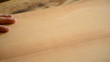 Luthier cuts wood with hacksaw, pan