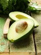 ripe avocado cut in half on a wooden table