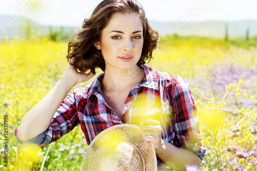 Photo: Portrait of young woman in the flowers field Portrait of young woman in the flowers field
