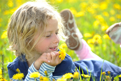 Photo: smiling girl in the spring- meadow smiling girl in the spring- meadow