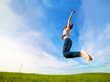 Young beautiful woman jumping for joy
