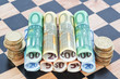 Paper money and coins as the euro on the chessboard. Concept Ima