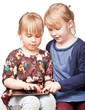 Foto: Girls playing with a tablet computer Girls playing with a tablet computer
