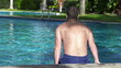 Young man swimming in the pool, super slow motion