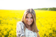 Sweet woman among yellow wildflowers in summer