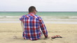Pensive man sitting on the beach