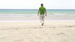 Casual man walking on beautiful beach