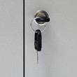 Photo: A key in keyhole with locking a cabinet A key in keyhole with locking a cabinet