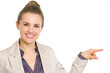 Smiling business woman pointing on copy space