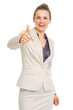 Happy business woman showing thumbs up