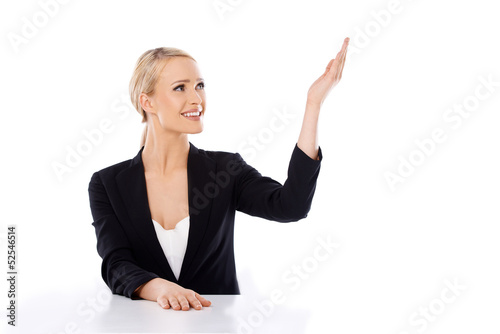 Photo: Blond business woman sitting at the desk Blond business woman sitting at the desk