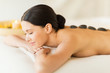 woman in spa with hot stones
