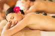 couple in spa with hot stones