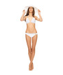 model posing in white bikini with hat
