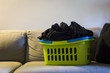 green laundry clothes basket standing couch
