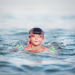 little girl swims and dives to the sea