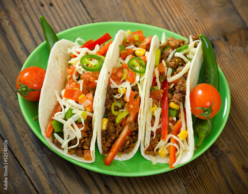 Photo: Beef taco on the plate with vegetables Beef taco on the plate with vegetables