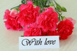 With love note and pink carnations